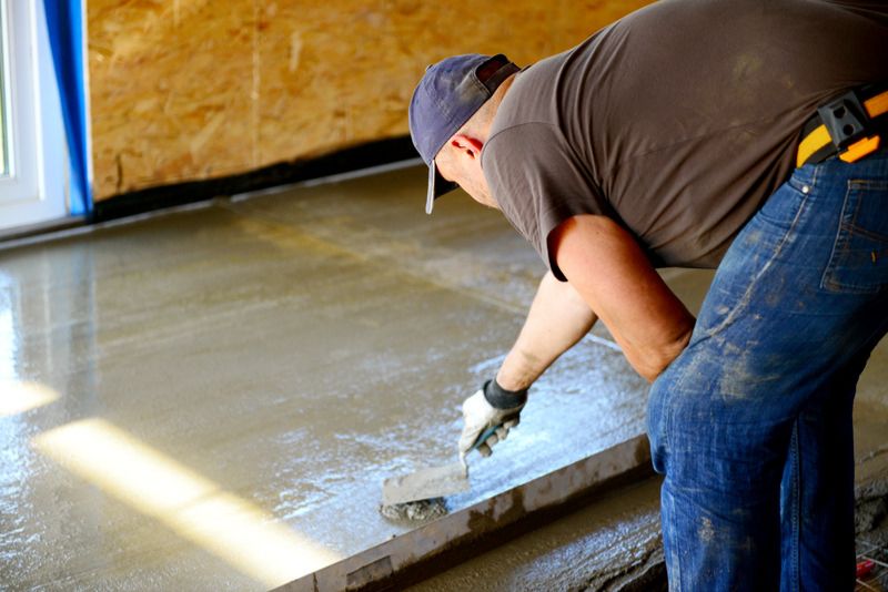 concrete worker finishing a concrete floor