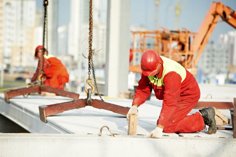 workers installing concrete floor at a building commercial site